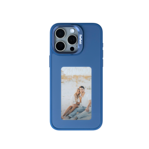 Reflekt™ blue E-Ink smart case for iPhone 15 showing a personalized photo of a couple on the back display.