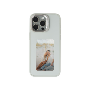 Reflekt™ gray E-Ink smart case for iPhone 15 showing a personalized photo of a couple on the back display.